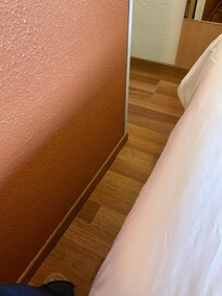 Very little space between the side of the bed and the wall