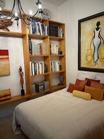 Second bedroom with surrounding library of books