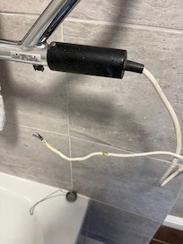 Wire hanging from bathroom radiator