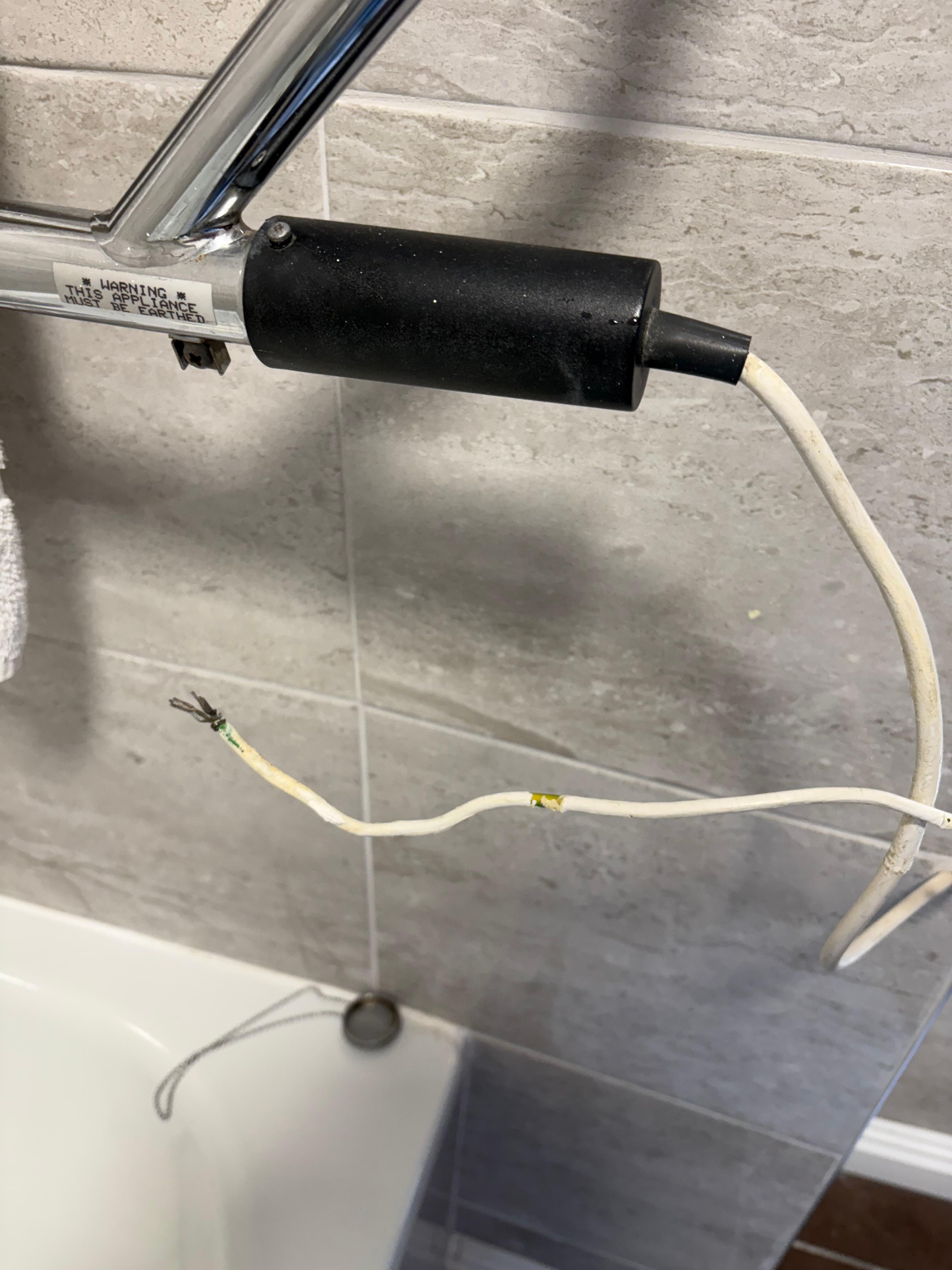Wire hanging from bathroom radiator