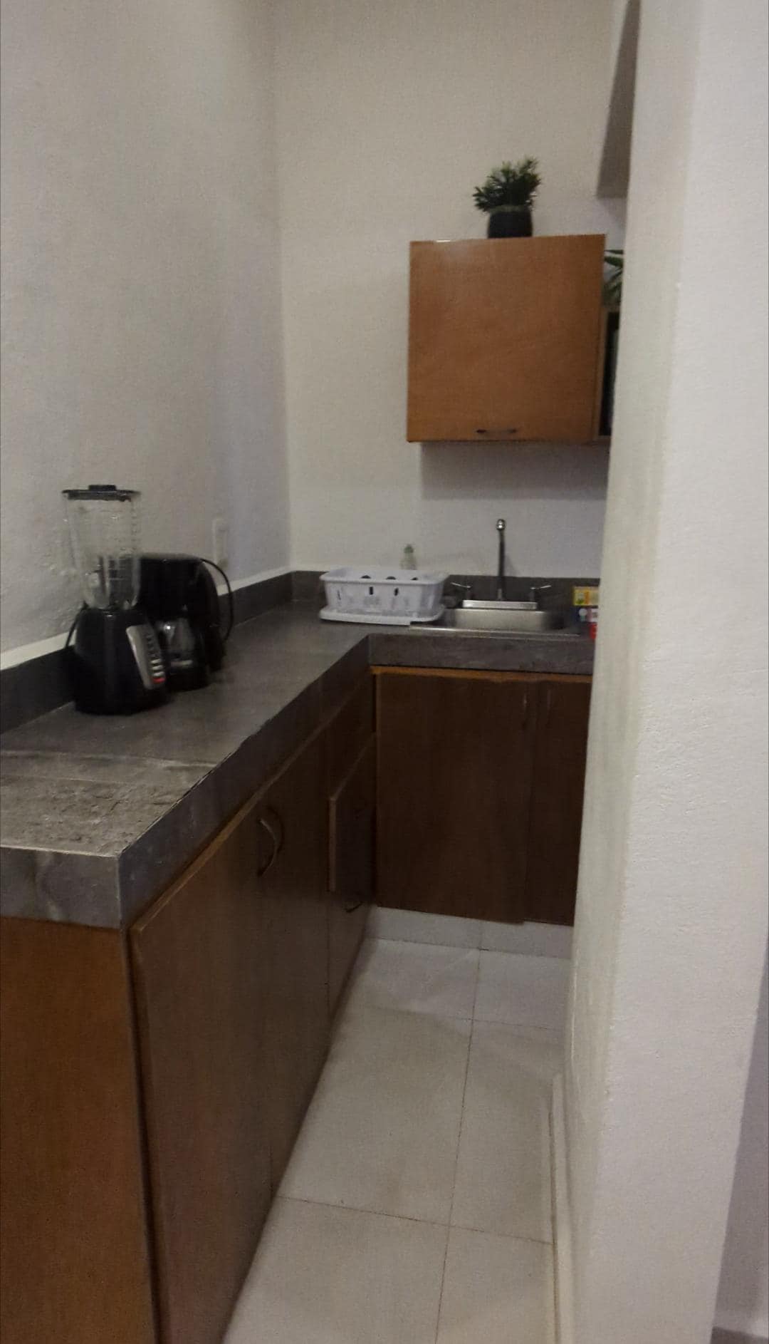 Lots of kitchen space.  Includes 2 cups, 2 plates, 2 mugs (all glass).  Bowls would have been helpful but we managed with the mugs.