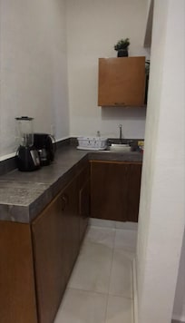 Lots of kitchen space. Includes 2 cups, 2 plates, 2 mugs (all glass). Bowls would have been helpful but we managed with the mugs.