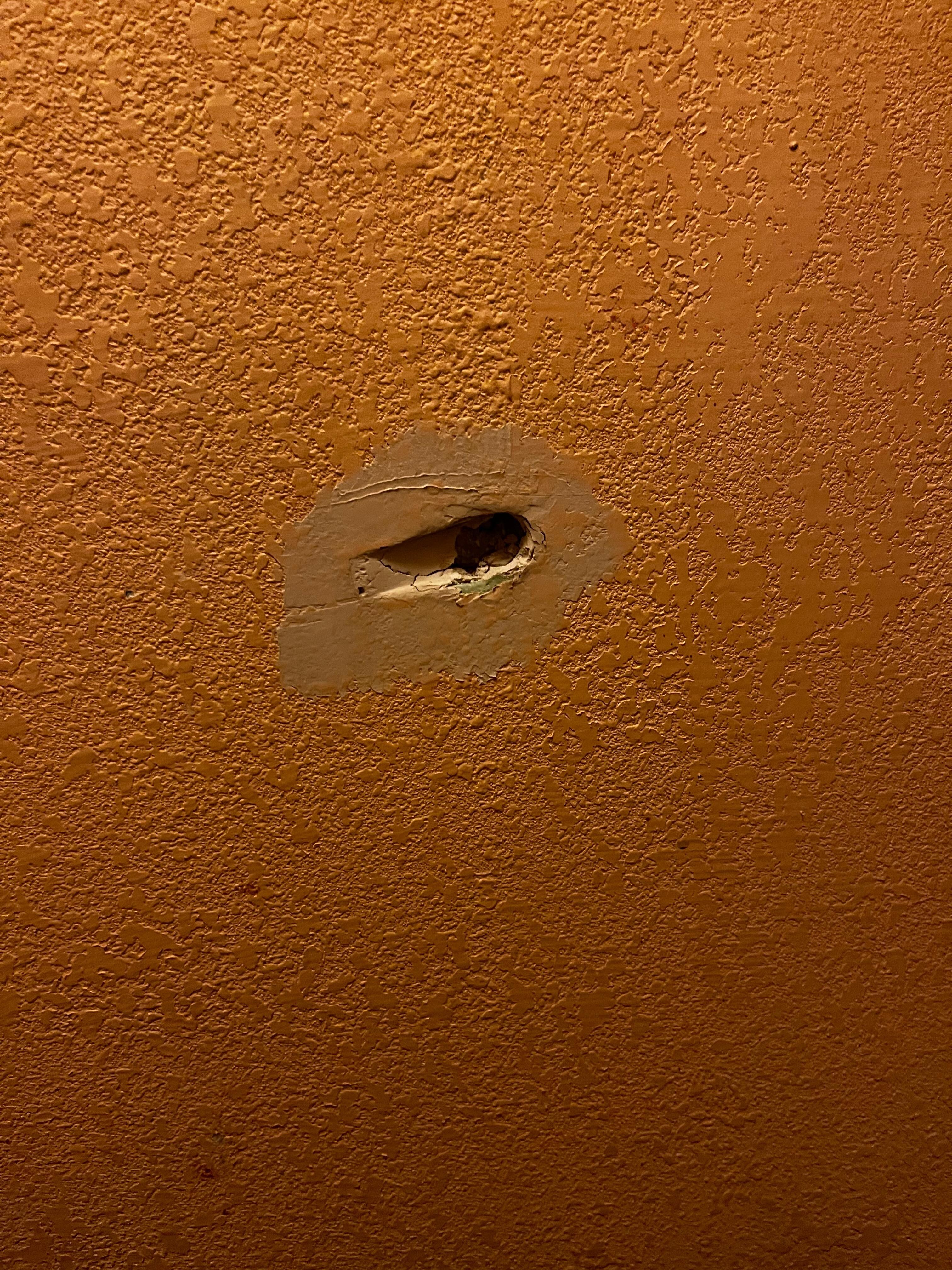 Hole in bathroom wall