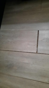 Gaps in flooring no grout, full of debri