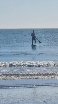 My son using the Paddle Board that was available, on the beach a 2 minute walk from the house.