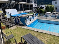 Tatty pool cover and water that has probably been there for years
