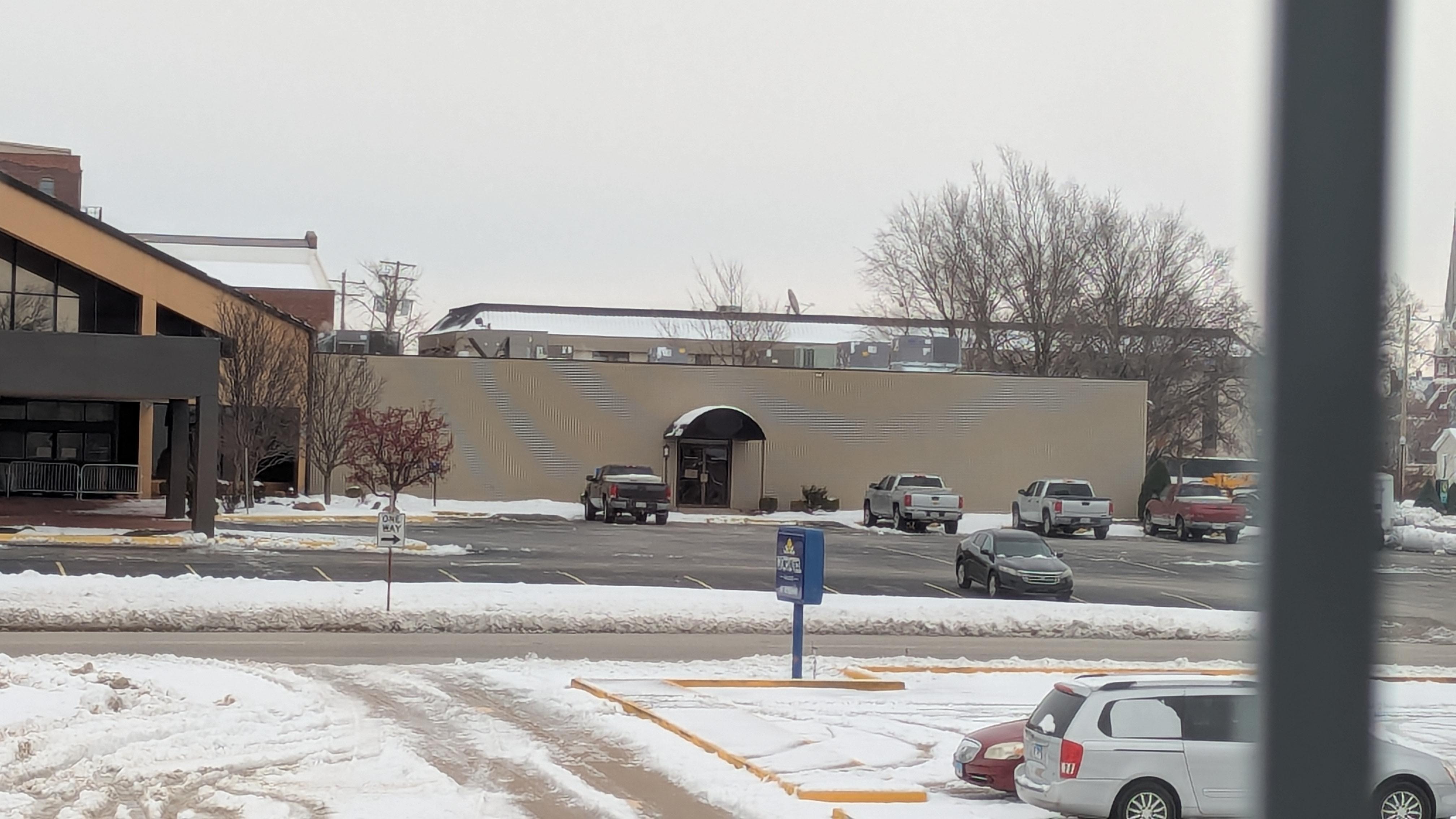This is a picture of the un-maintained parking lot after the snow storm. As well as the clear parking lot across the street that WAS plowed and maintained 