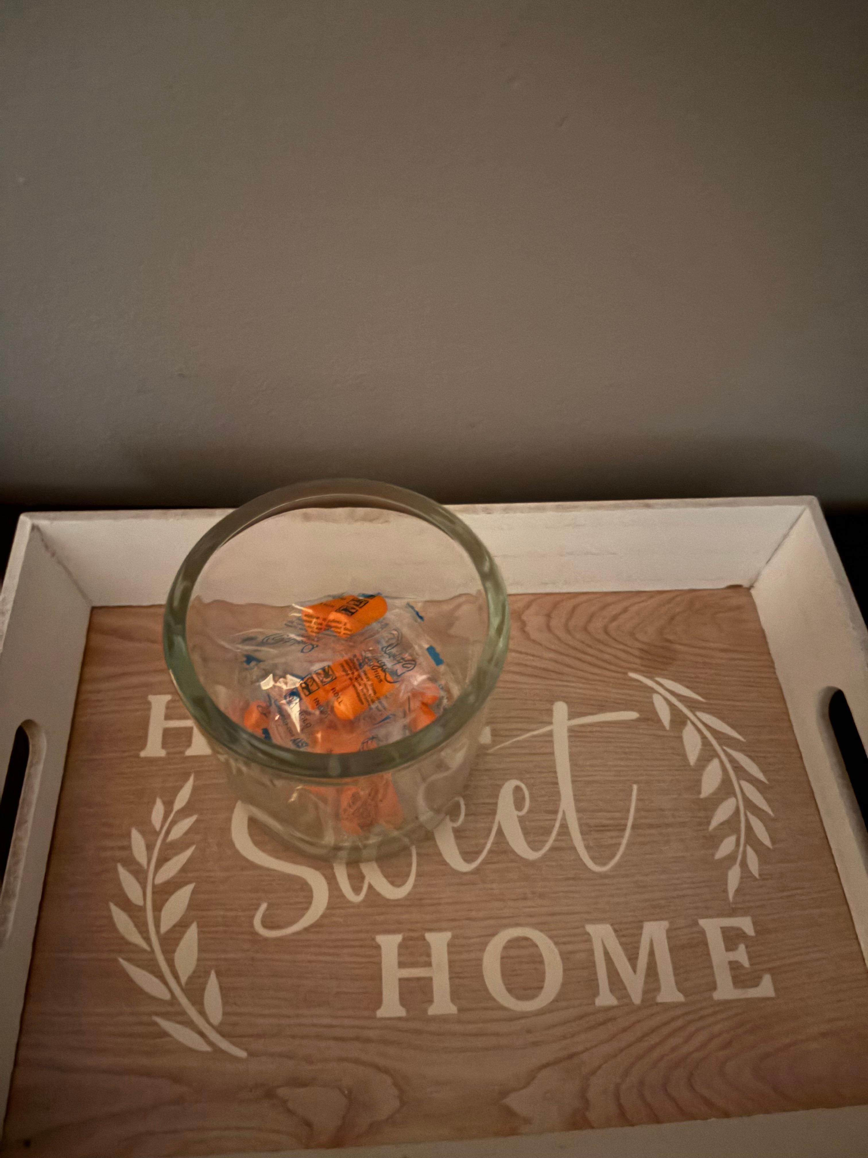 A jar with ear plugs in each bedroom.