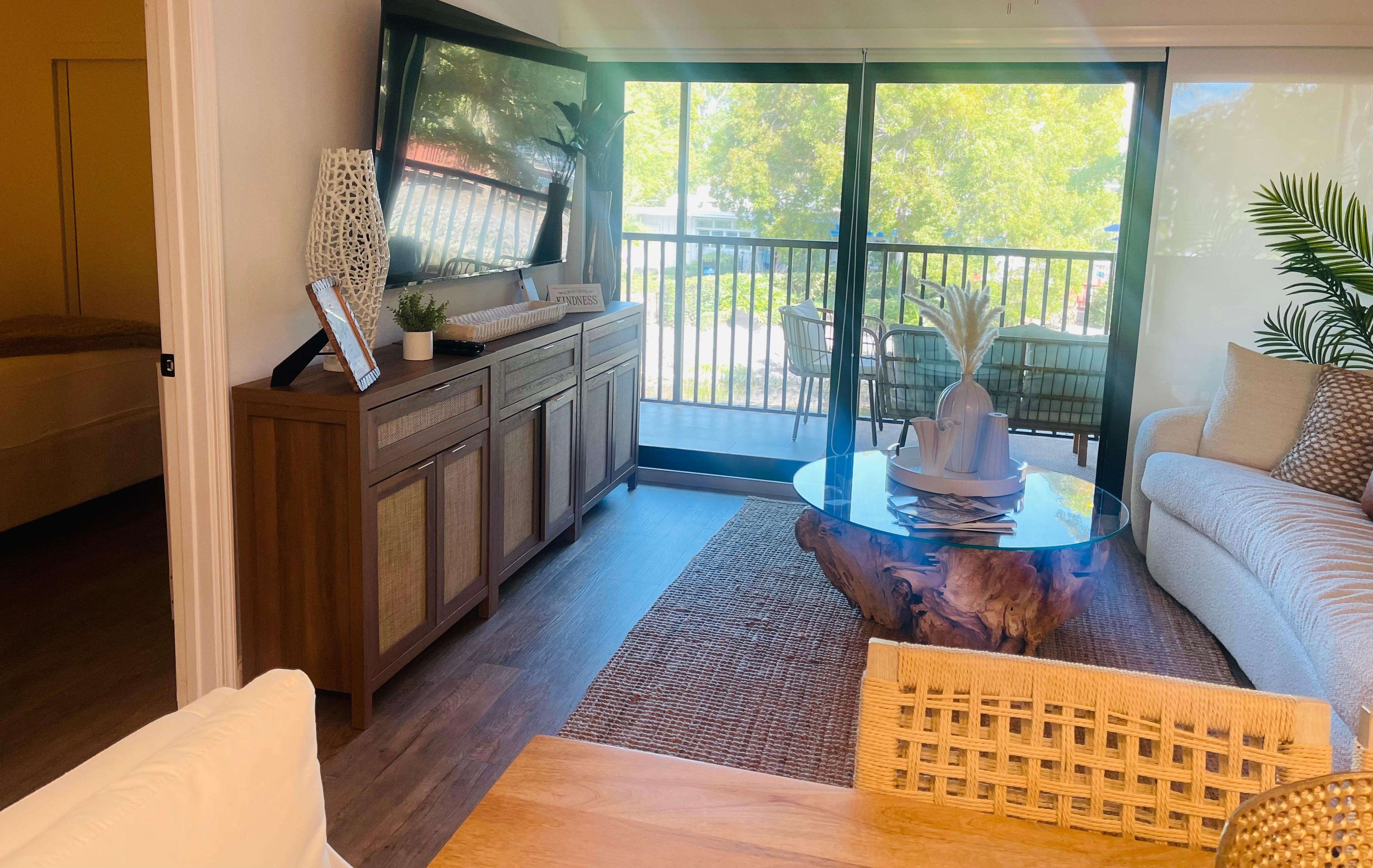Living room with full sliding glass door to screened in porch. 