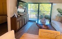 Living room with full sliding glass door to screened in porch.
