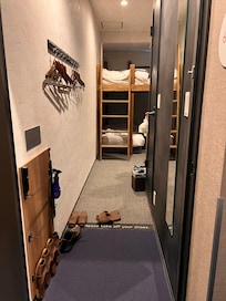 Bathroom with bidet toilet, walk in shower, and nice olive shampoo, conditioner, and body soap