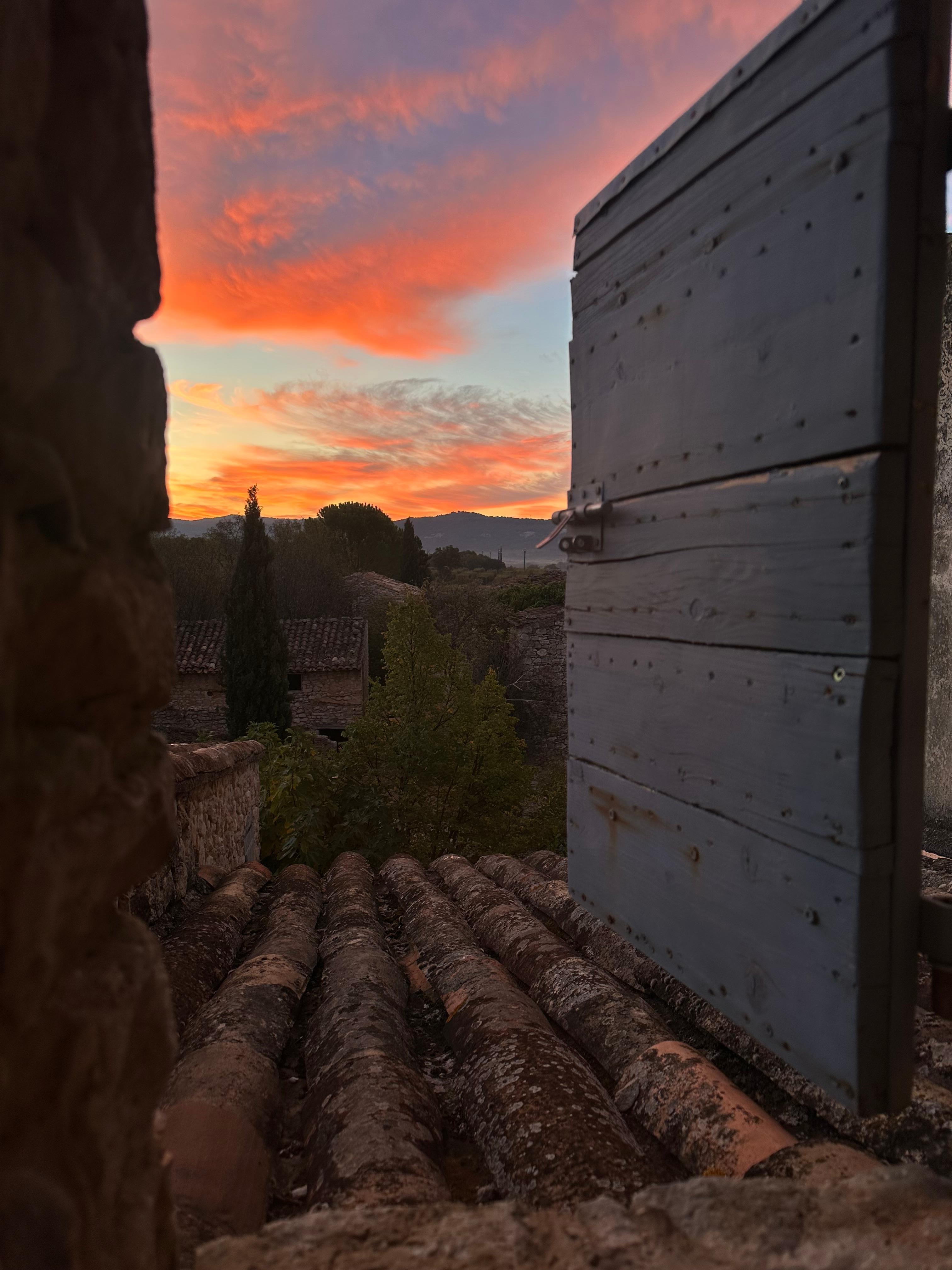 The sunrise over the mountains from a bedroom window. 