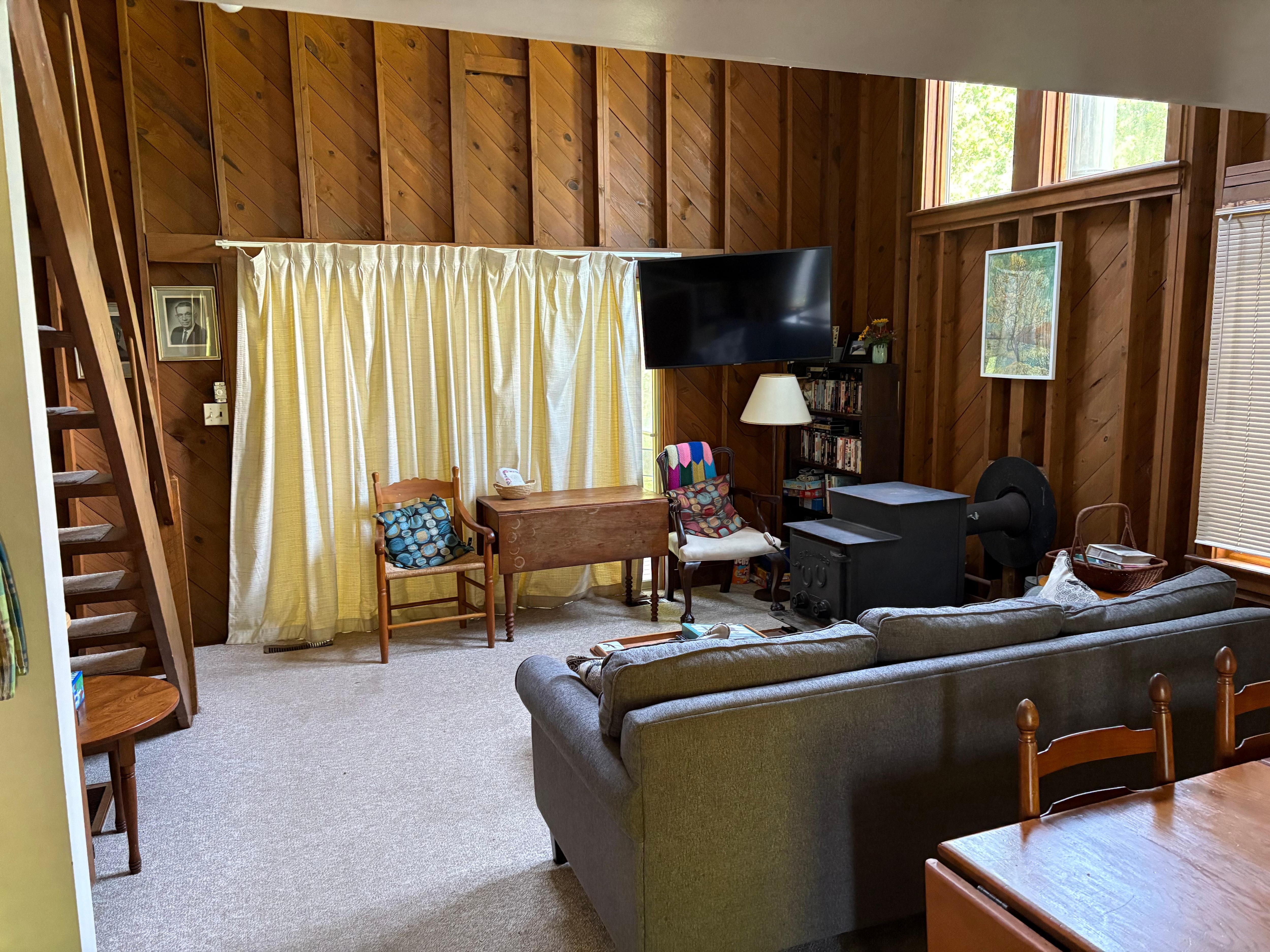 Living room space and back deck behind the curtain. 