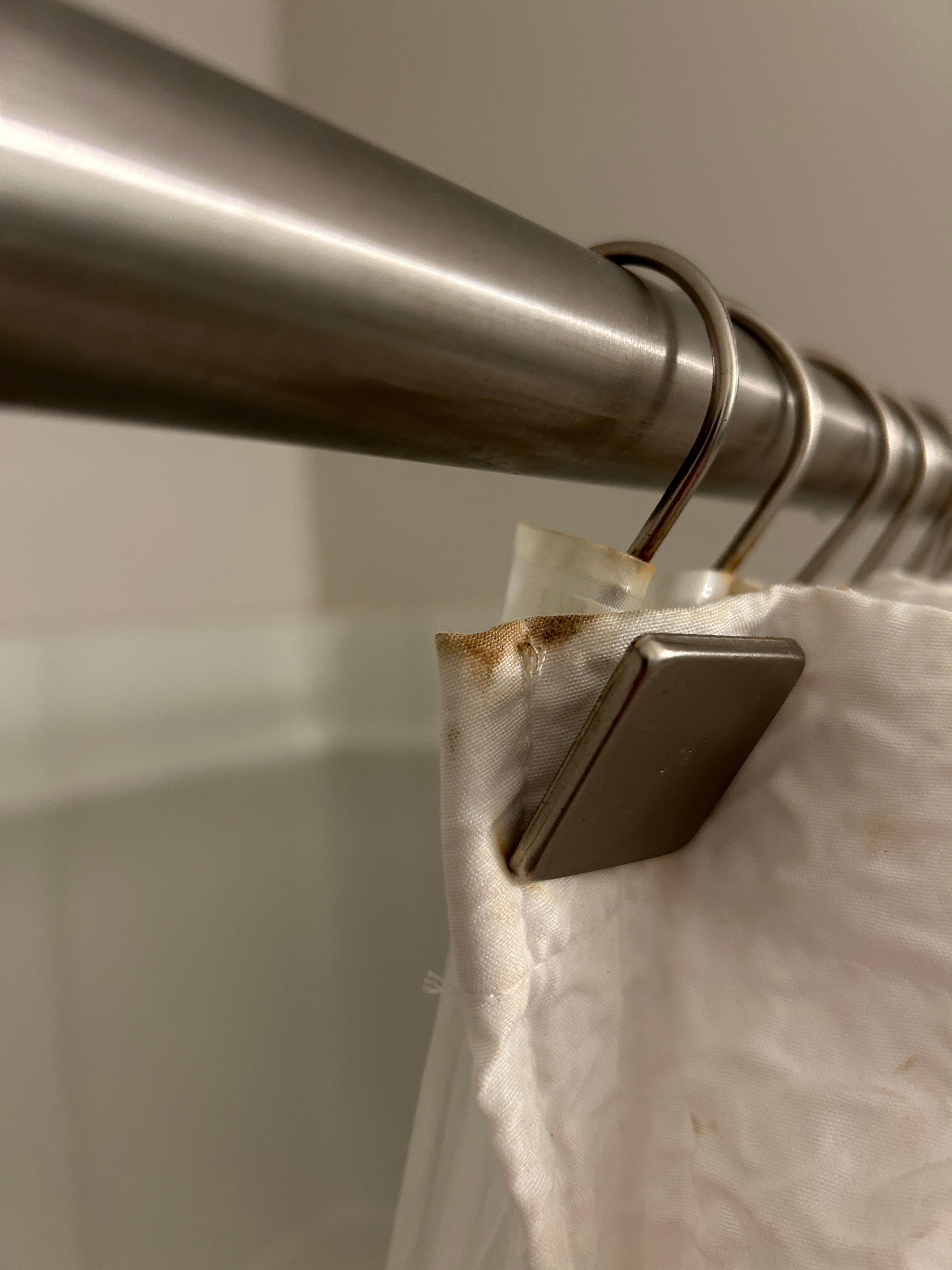 rusty shower curtain rings in upstairs guest room