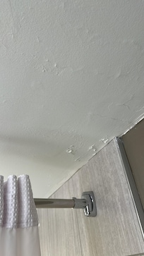 Peeling paint on bathroom ceiling