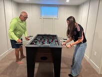 Pa playing foosball with granddaughter. She had her own suite downstairs Perfect for a teenager