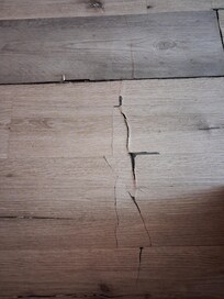 Very fragile flooring in main bedroom leading into bathroom. Not repaired.