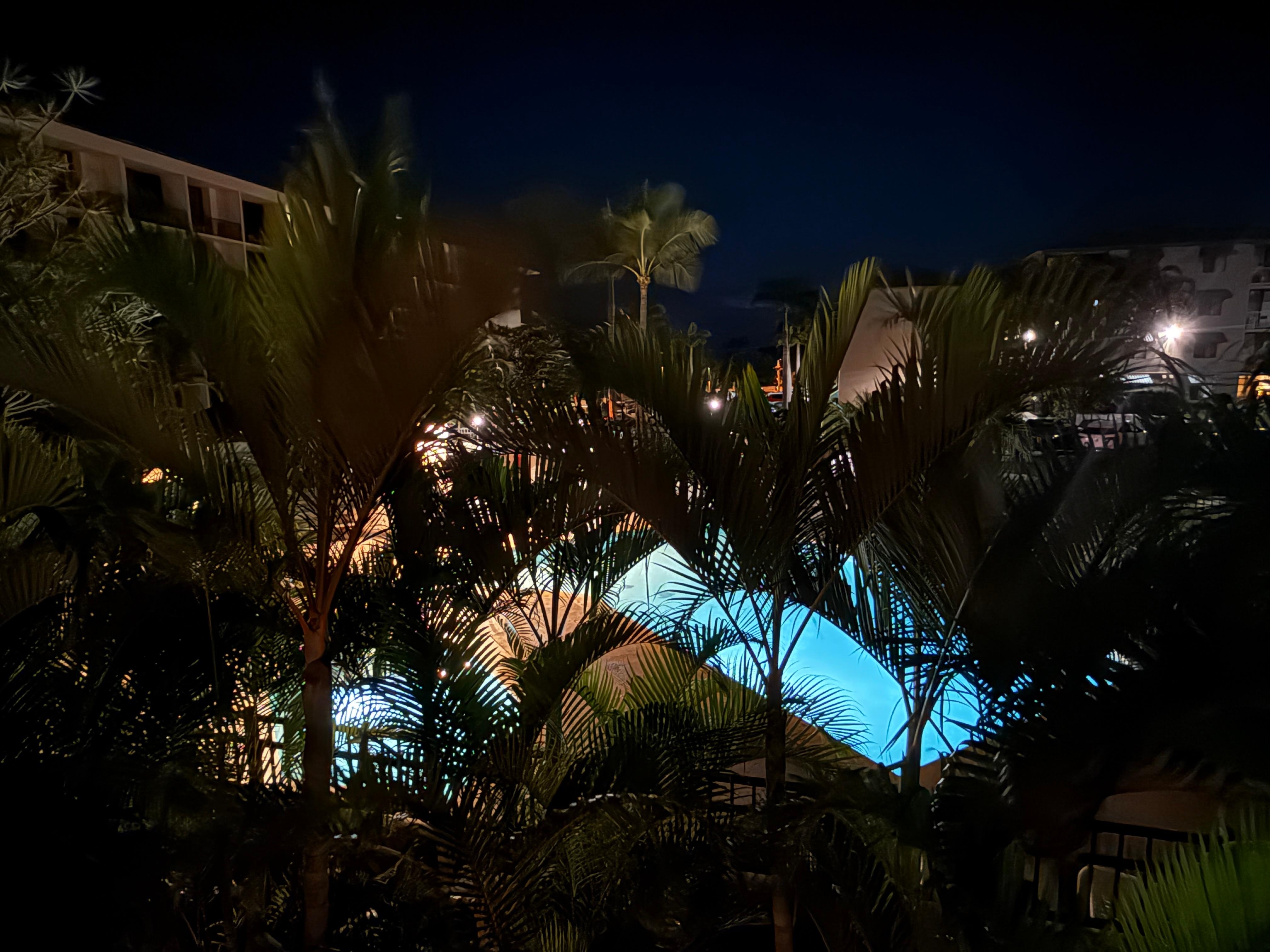 The view of the pool and grill area at night. 