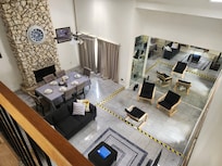 Caution tape, though unsightly, is wise. Several split layers downstairs that could definitely be a fall hazard. Recommend a simple table or bookshelf to hide the wifi mess there on the floor.