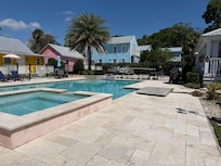 Hot tub & pool with cottages in background
