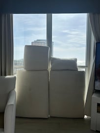 Us placing the couch pillow in the window to try to dry faster