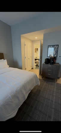 Dresser, closet and access to the bathroom