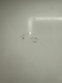 On counter beside sink