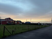 From the road that leads into the parking lot shared with a coffee company.