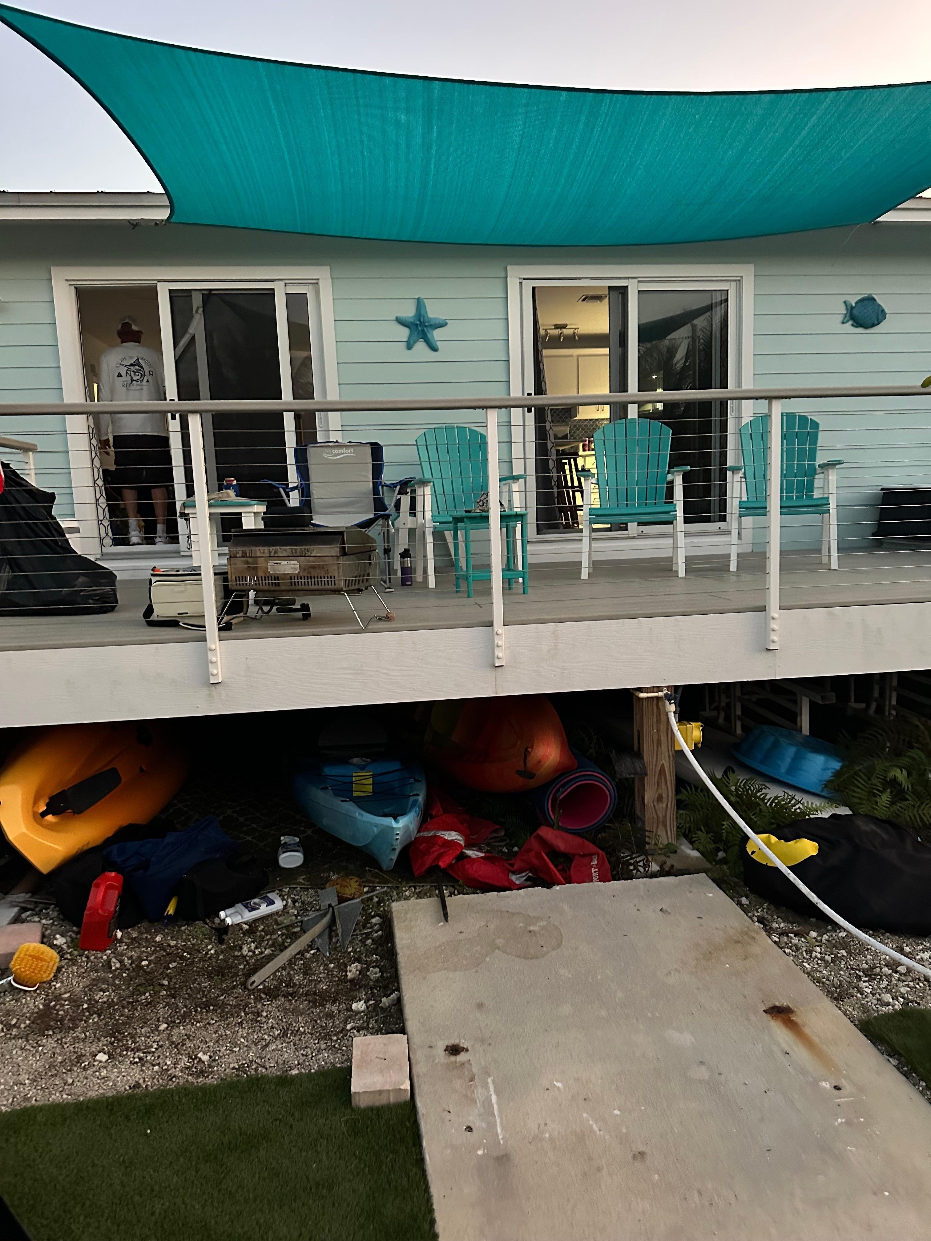 Wonderful shaded porch with kayaks and paddle boards ready to go