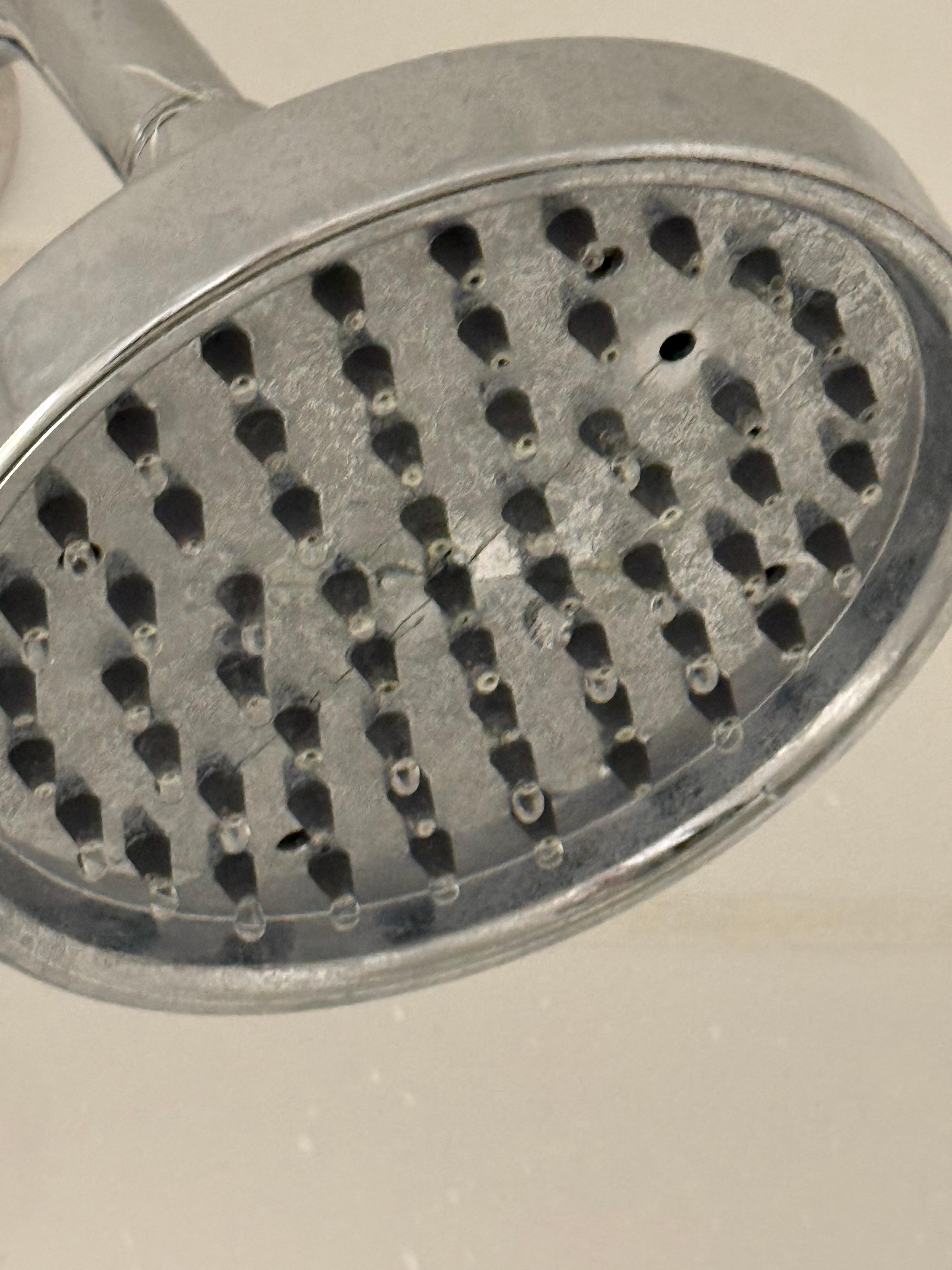 Shower head with one giant hole spraying a harsh stream that reddens your skin