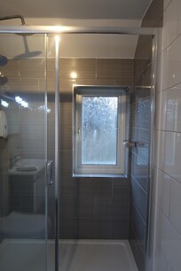 Shower unit in spacious bathroom