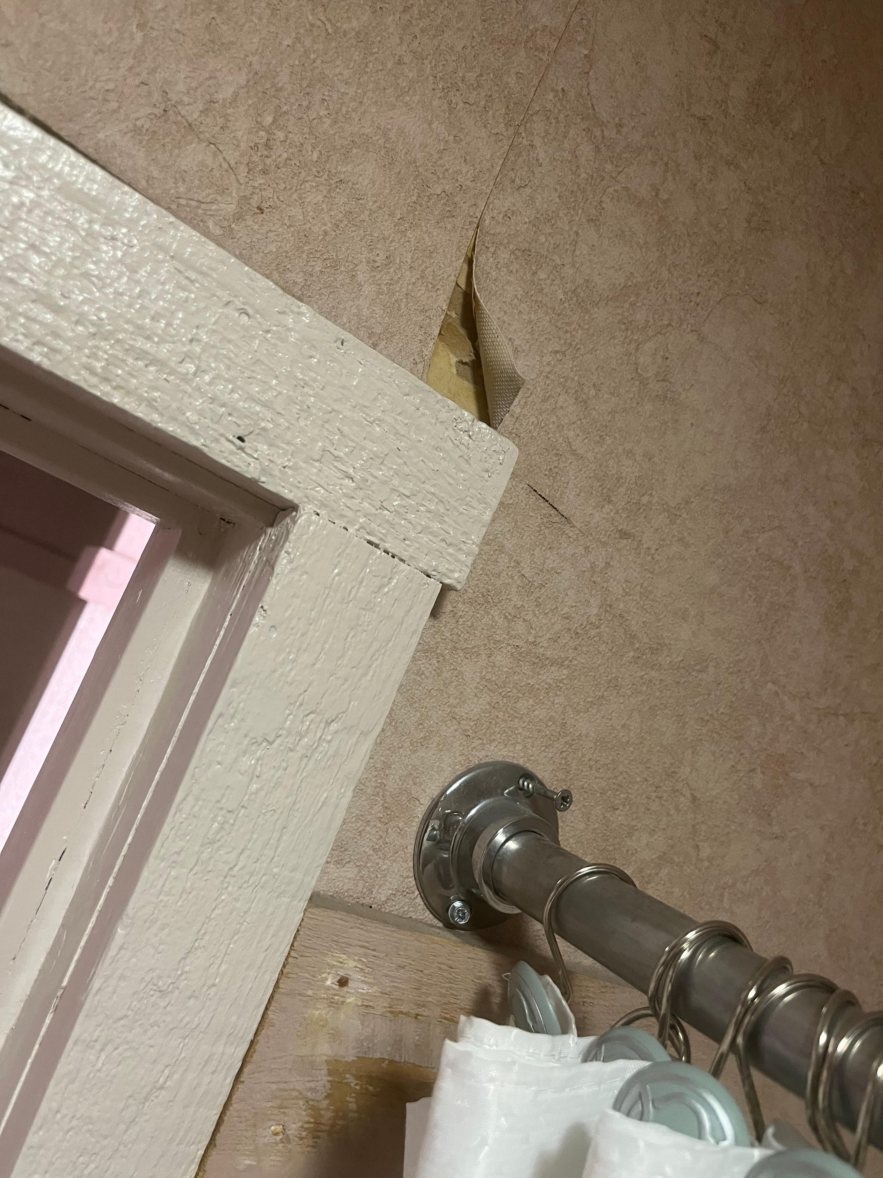 Shower curtain rod not even screwed into the wall