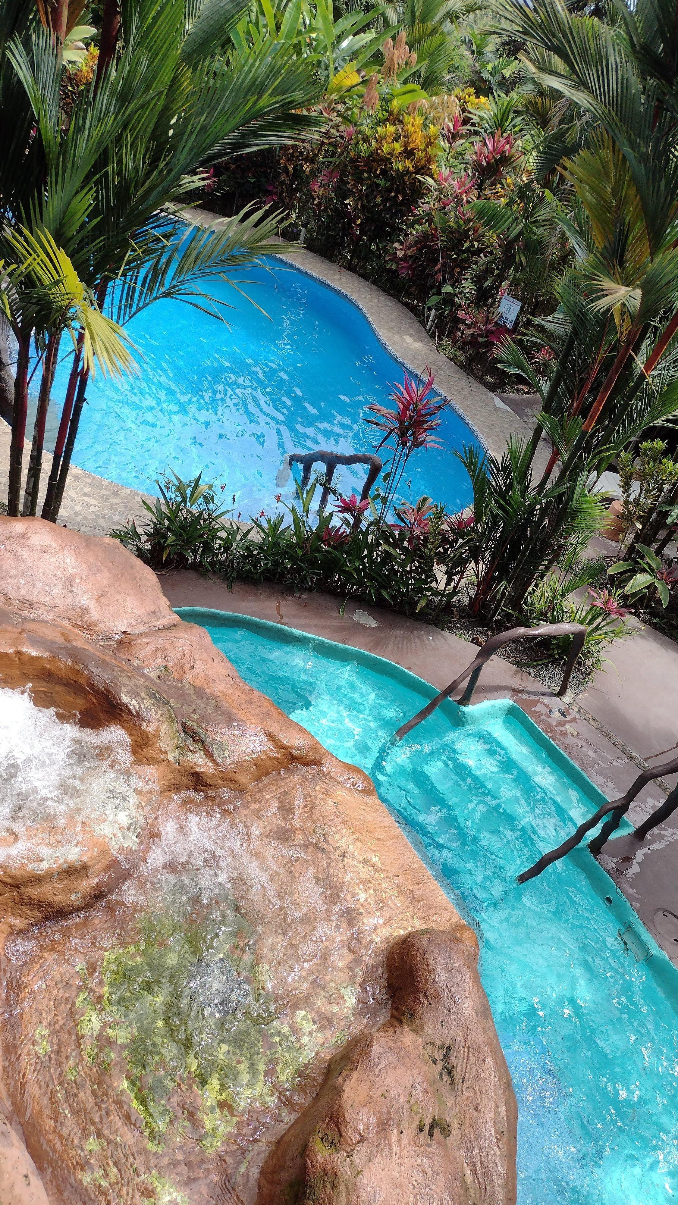 View of pools from top terrace that has hammocks to relax in.