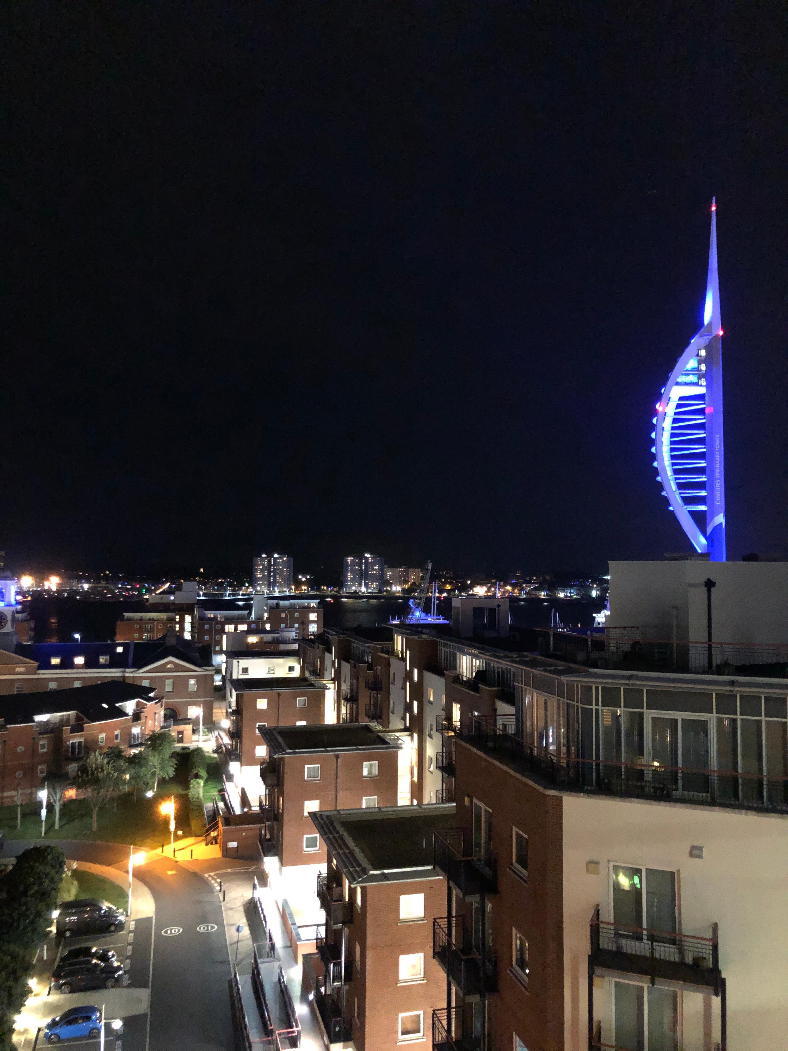 The Spinnaker lit at night.