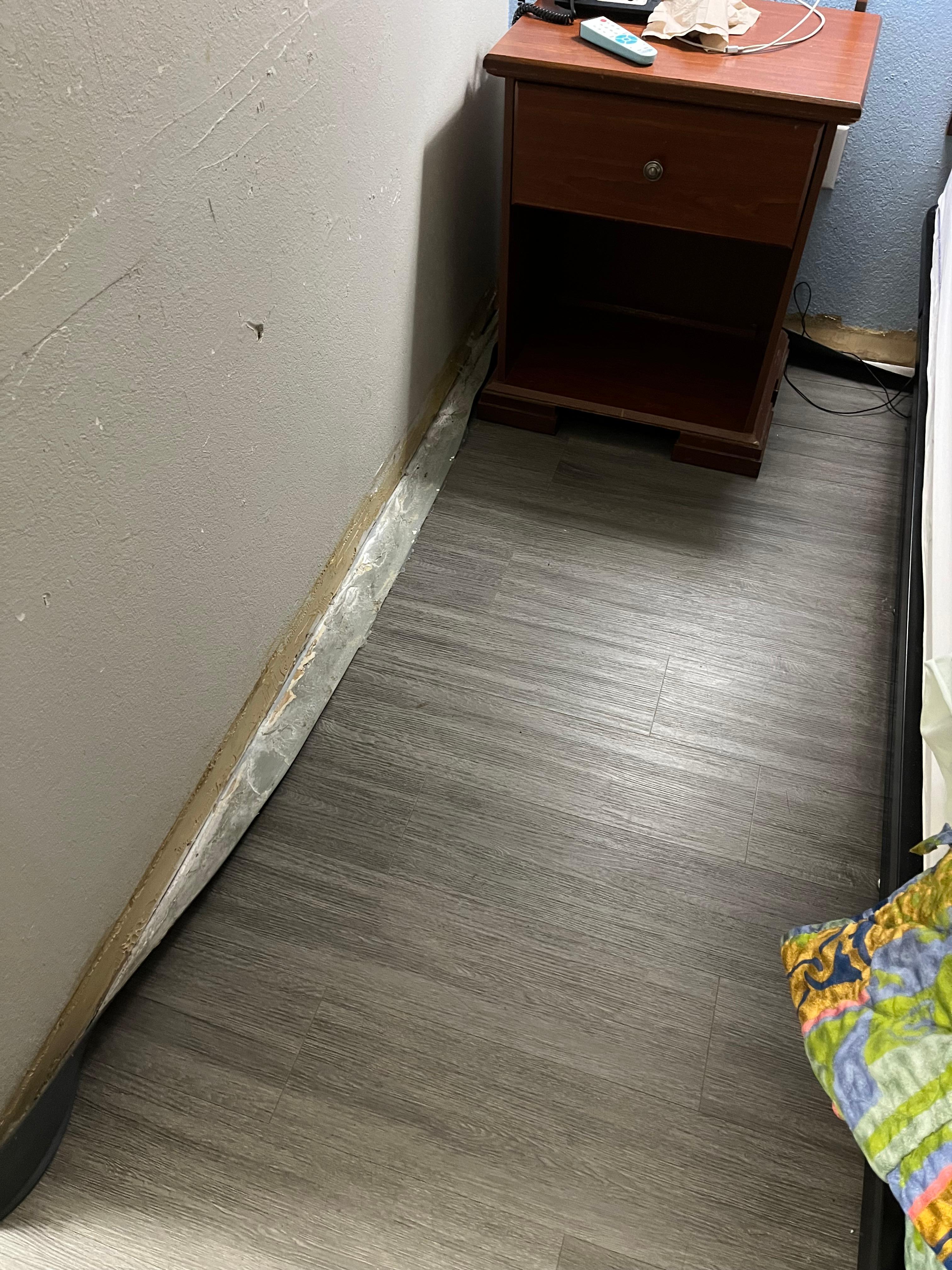 Baseboard with all kinds of crud on/behind it