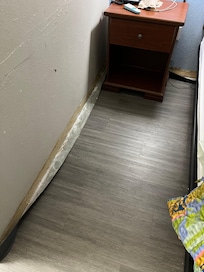 Baseboard with all kinds of crud on/behind it