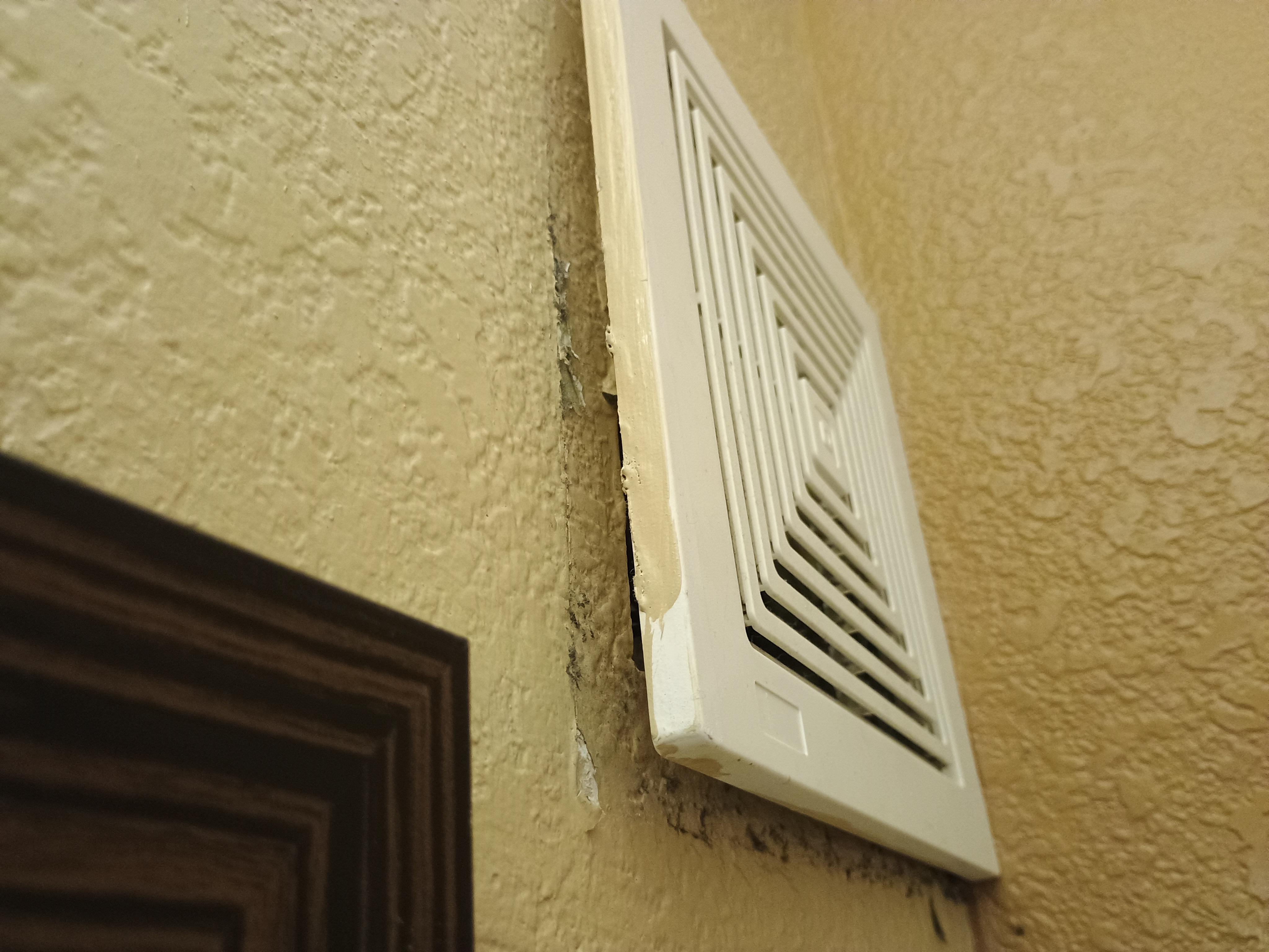 This vent was just hanging loosely on the wall, with what looked like black mold around it.