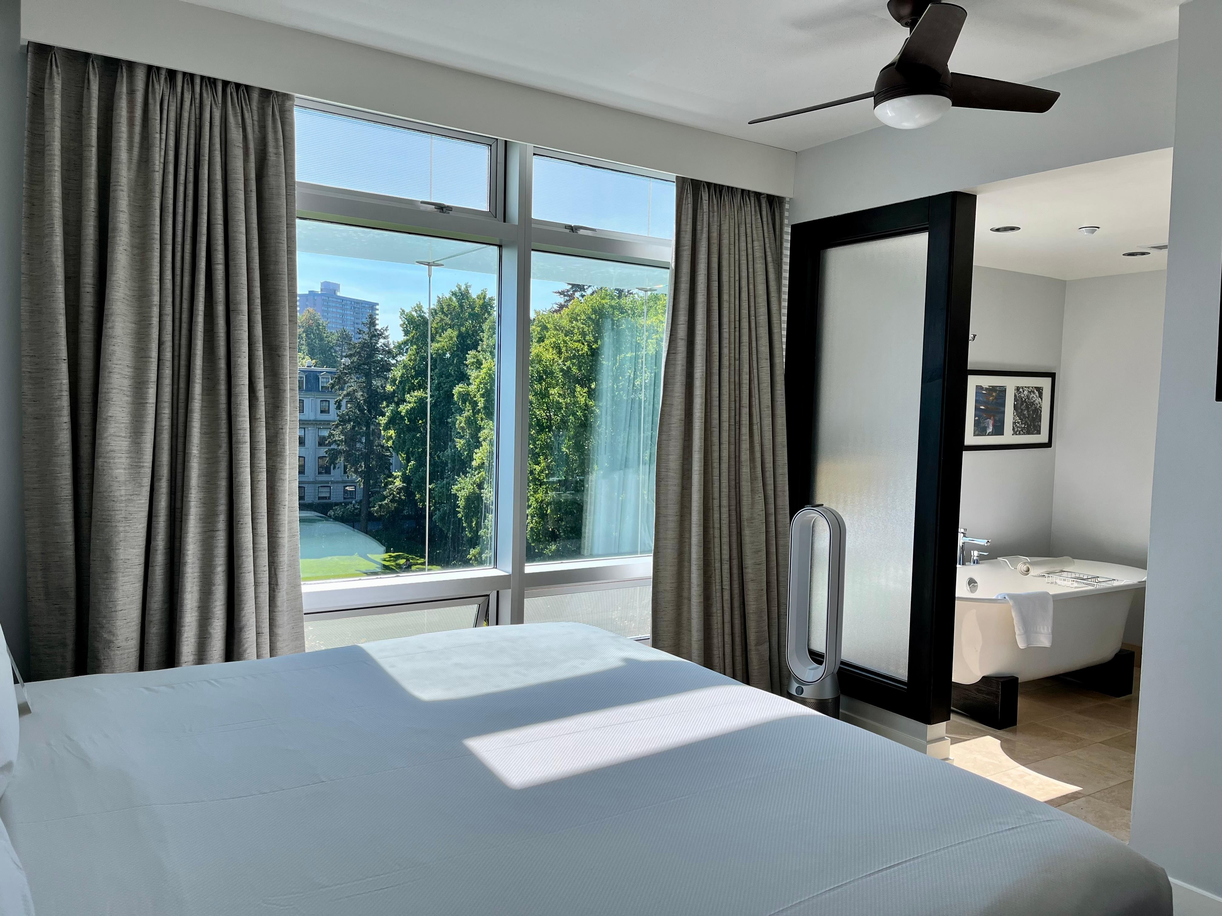 A lovely bedroom and soaking bathtub.