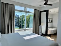 A lovely bedroom and soaking bathtub.