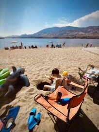 Hanging out mid-afternoon at the lakefront beach, just steps from the cottage. Nothing better than having the water right outside your door—sun, sand, and total relaxation.
