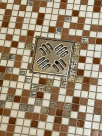 Missing tile in the shower. Cut my toe on one of the edges.