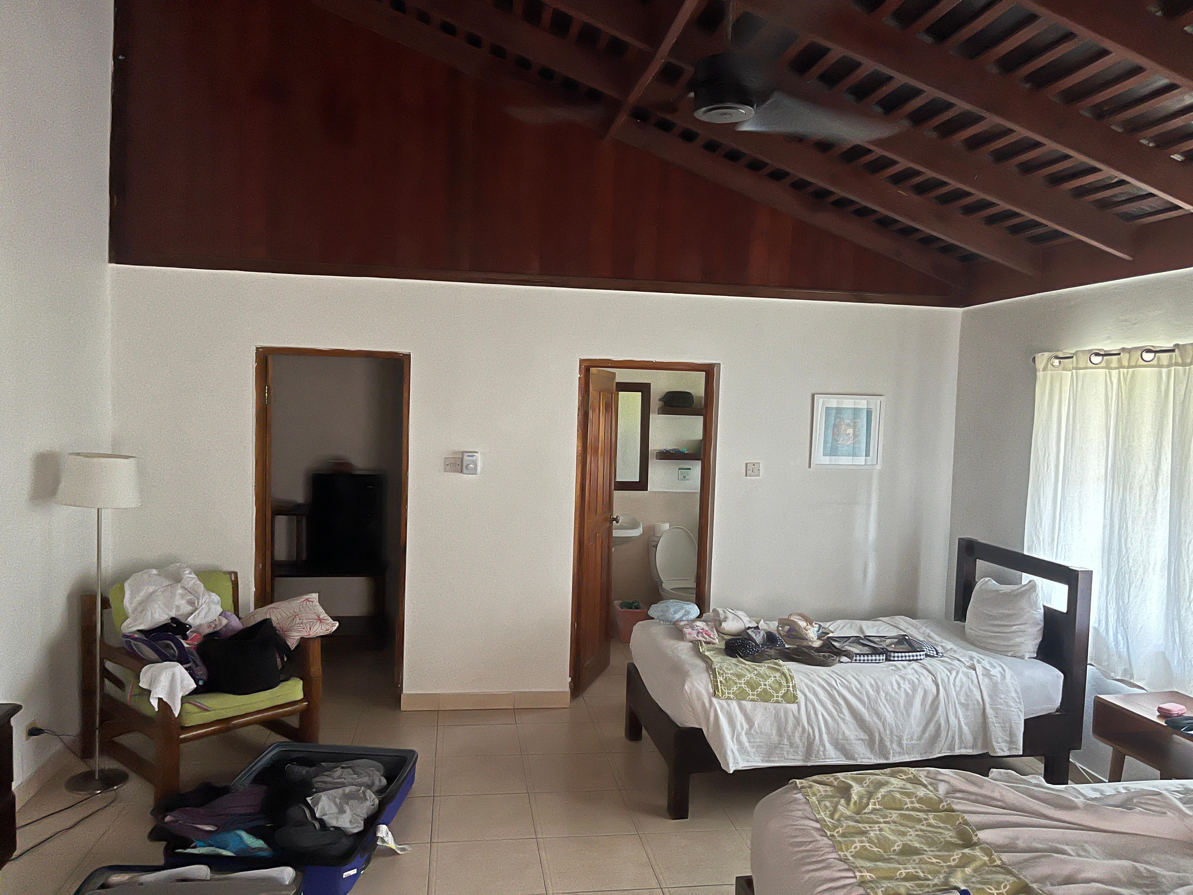 Deluxe bedroom showing bathroom and fridge/closet area.