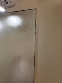 Moldy around the mirror.