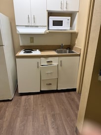 Broken caninetry; non-sanitized kitchen