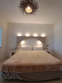 Room with queen bed and twin. Fridge, tv.