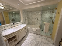 Bathroom with large tub, shower and two separate sink areas
