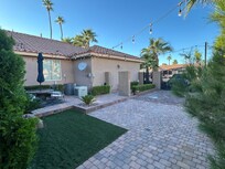 Private, gated courtyard with tables and chairs.