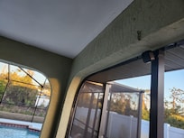 Camera facing sitting area by pool