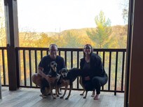 This is a view outside of the kitchen and dining room from the covered deck along the back side of the home.
