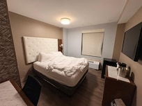 "Master" Room with desk refrigerator and coffee maker.